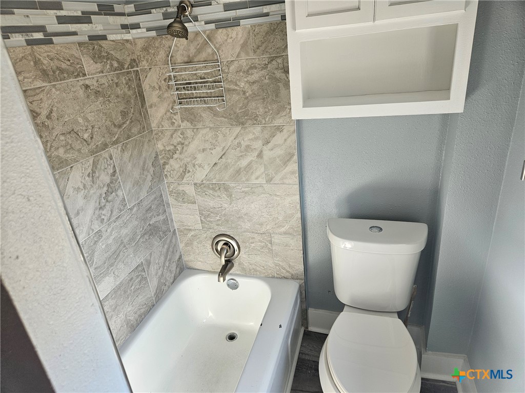 917 South 4th Street Temple, TX 76504 - Photo 18 of 30 a bathroom with a toilet sink and shower