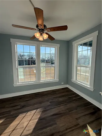 a view of a livingroom with wooden floor and staircase