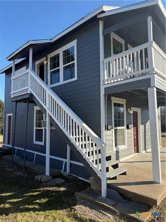 a view of a house with wooden fence