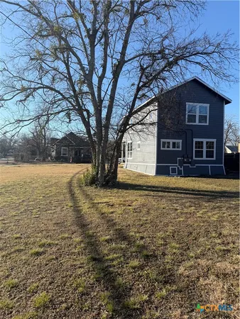 a large tree in front of a house