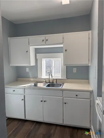 a white refrigerator freezer sitting inside of a kitchen