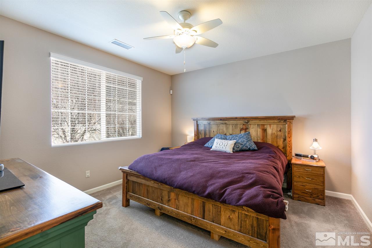 11057 Colton Drive Reno, NV 89521 - Photo 13 of 22 a bedroom with a bed and a window
