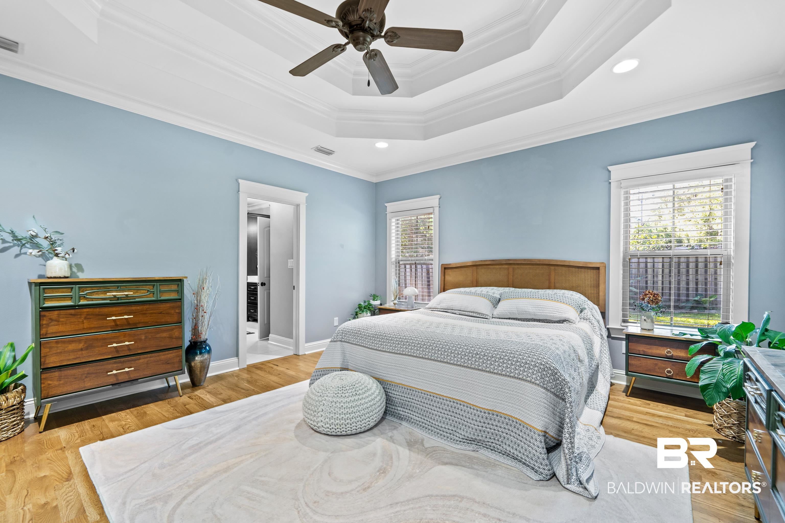 31829 Butler Drive Daphne, AL 36527 - Photo 24 of 48 Bedroom featuring ceiling fan, light wood-type flooring, crown molding, and a raised ceiling