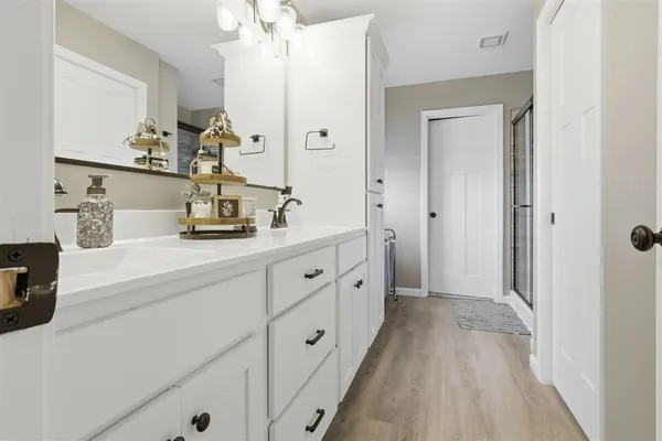 a spacious bathroom with double vanity sink and mirror