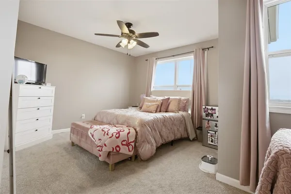 a bedroom with a bed and a chandelier