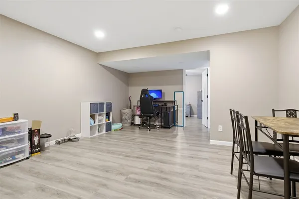 a view of a room with furniture and wooden floor