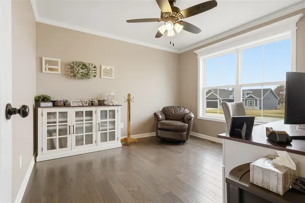 a living room with furniture and a floor to ceiling window