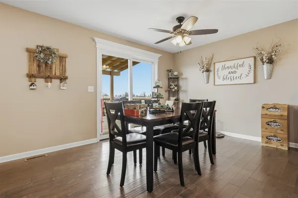 a view of a dining room with furniture and wooden floor