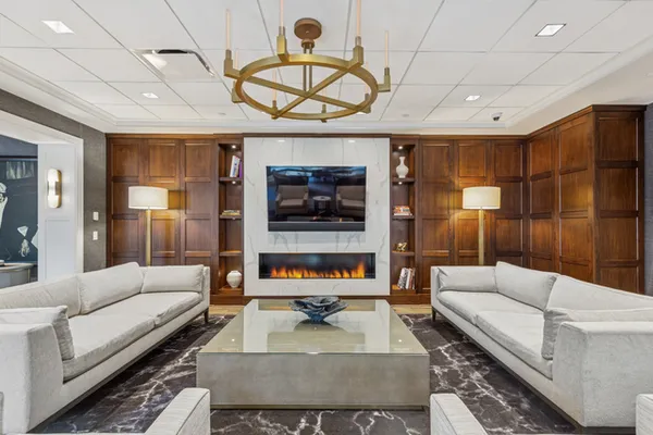 a living room with furniture a ceiling fan and a rug