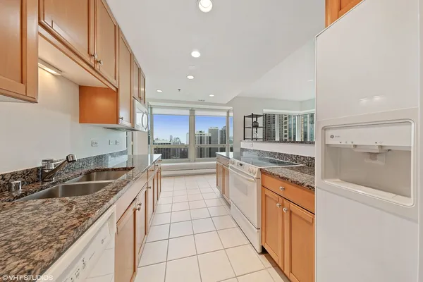 a kitchen with stainless steel appliances granite countertop a sink and cabinets