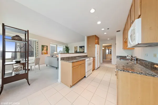 a kitchen with a sink and chairs