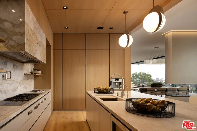 a living room with furniture and kitchen view