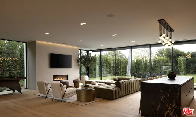 a living room with furniture a flat screen tv and a large window