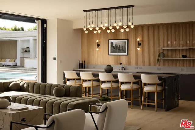 a living room with fireplace furniture and a large window