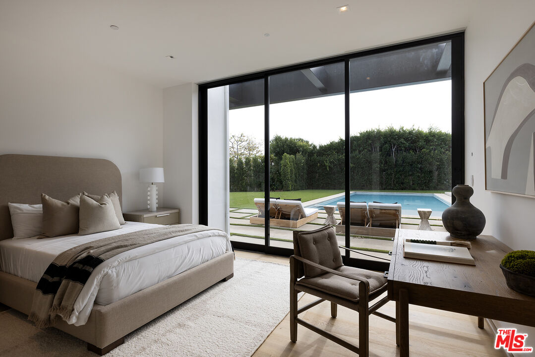 1660 Casale Road Pacific Palisades, CA 90272 - Photo 36 of 44 a bedroom with a bed and a balcony