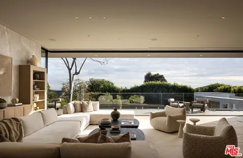 a view of roof deck with couches and wooden floor