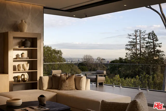 a living room with furniture a large window and a table