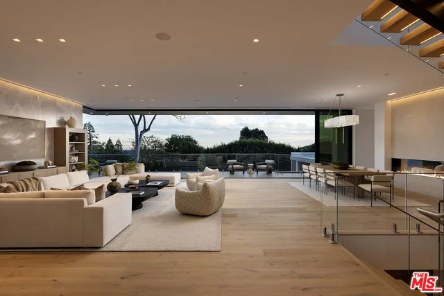 a living room with furniture and stairs