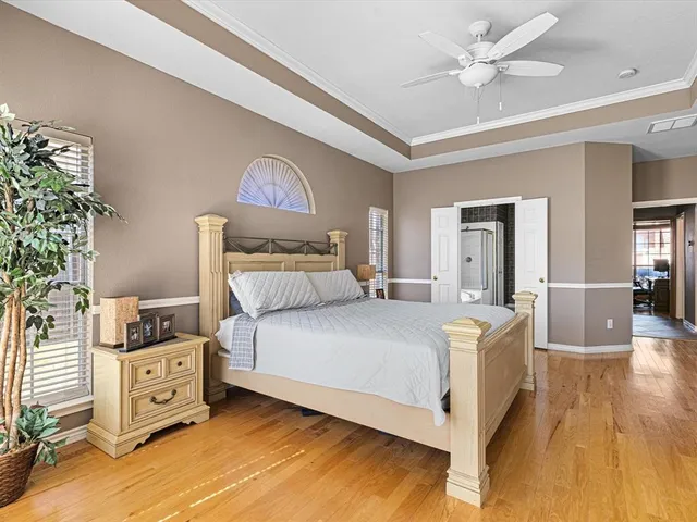a bedroom with a bed and a chandelier