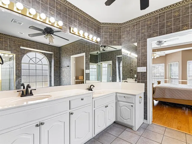 a bathroom with a sink vanity and mirror
