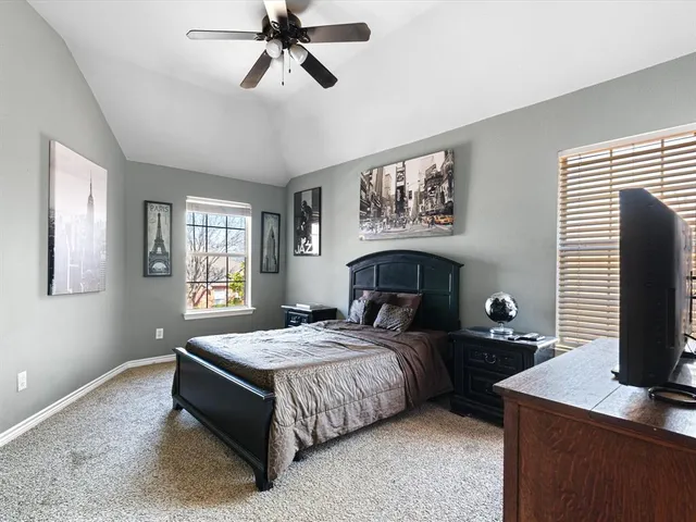 a bedroom with a bed table and window
