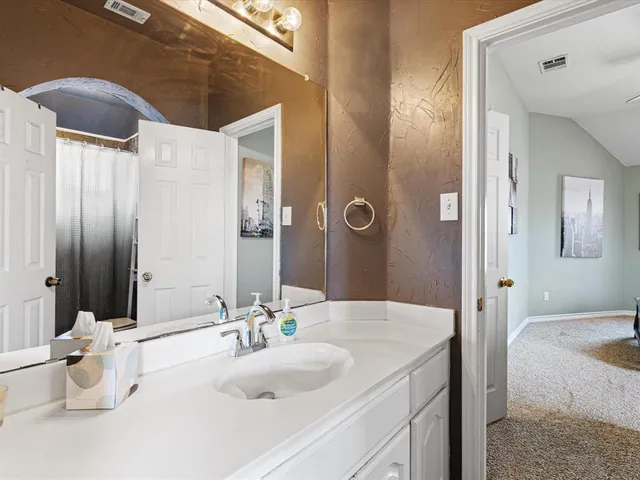 a bathroom with a double vanity sink and a mirror