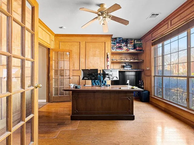 a living room with large windows and furniture