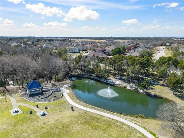 a view of a lake with boats and trees in the background