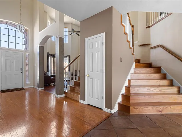 a view of entryway and hall with wooden floor