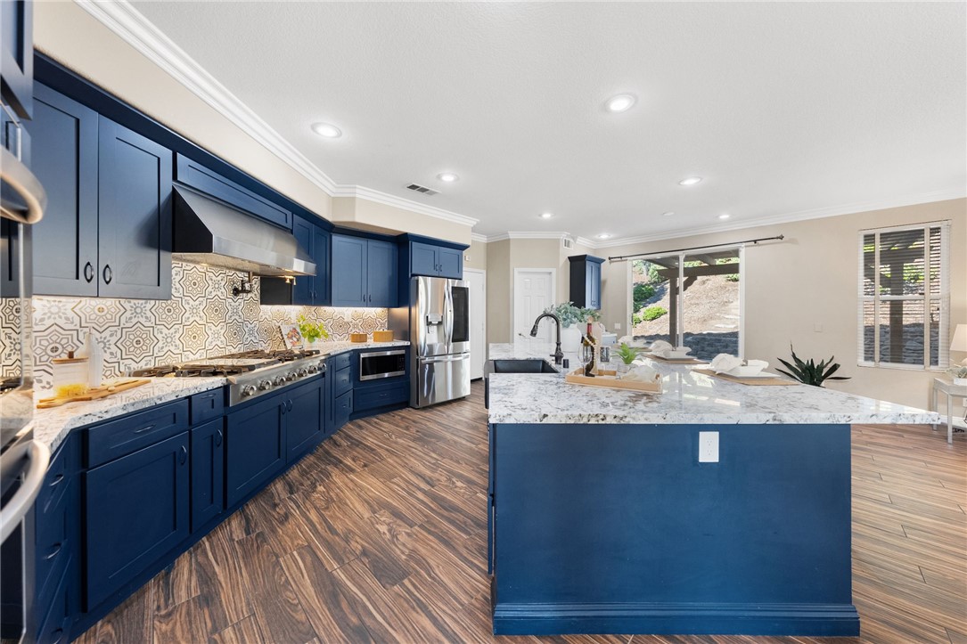 31465 Inverness Court Temecula, CA 92591 - Photo 17 of 75 Beautifully designed chefs kitchen showcases an oversized granite island with generous space for gathering and entertaining | Professionally Staged