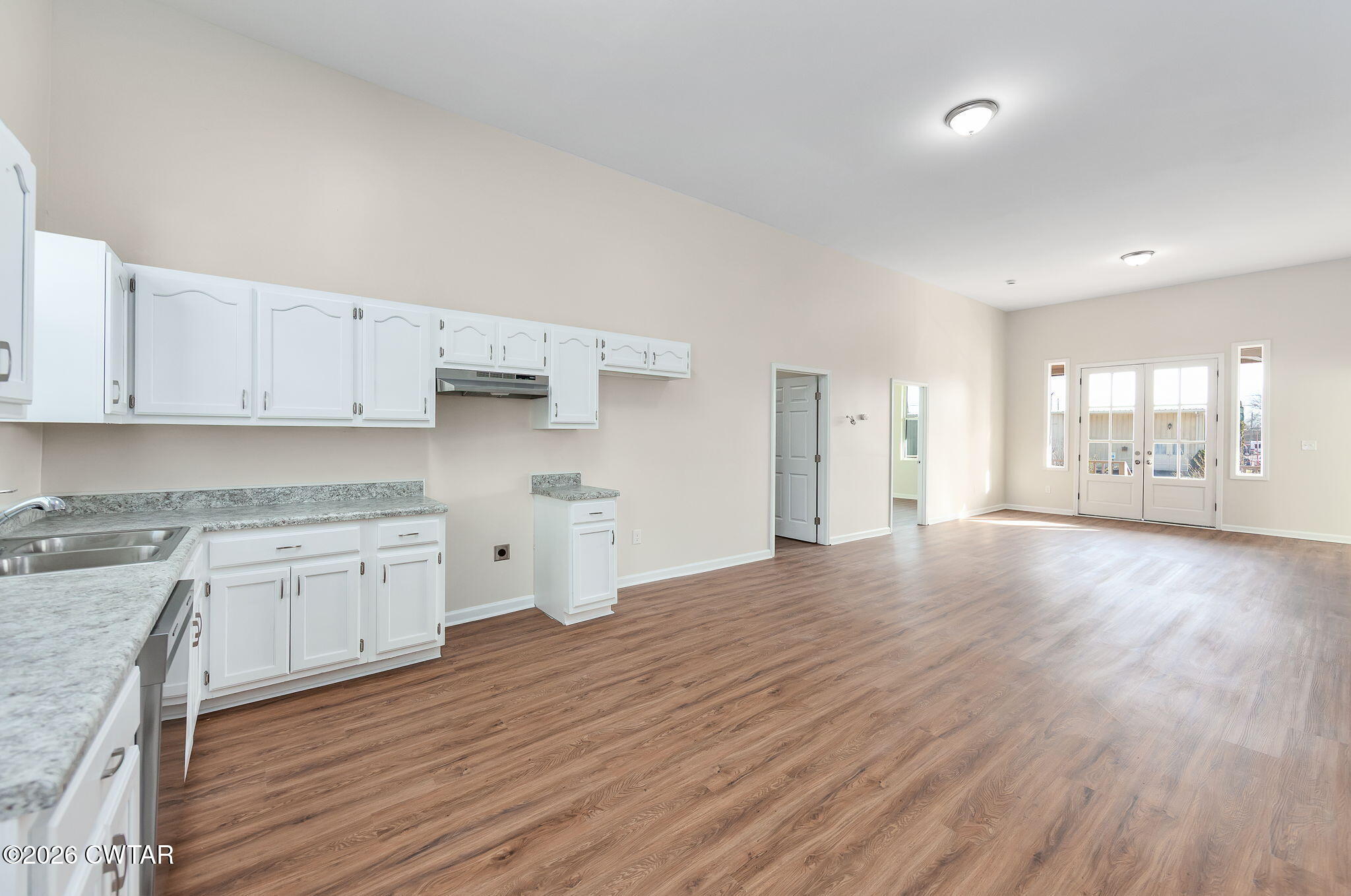 200 Lambuth Boulevard Jackson, TN 38301 - Photo 15 of 28 a open kitchen with granite countertop a stove top oven a sink and white cabinets with wooden floor