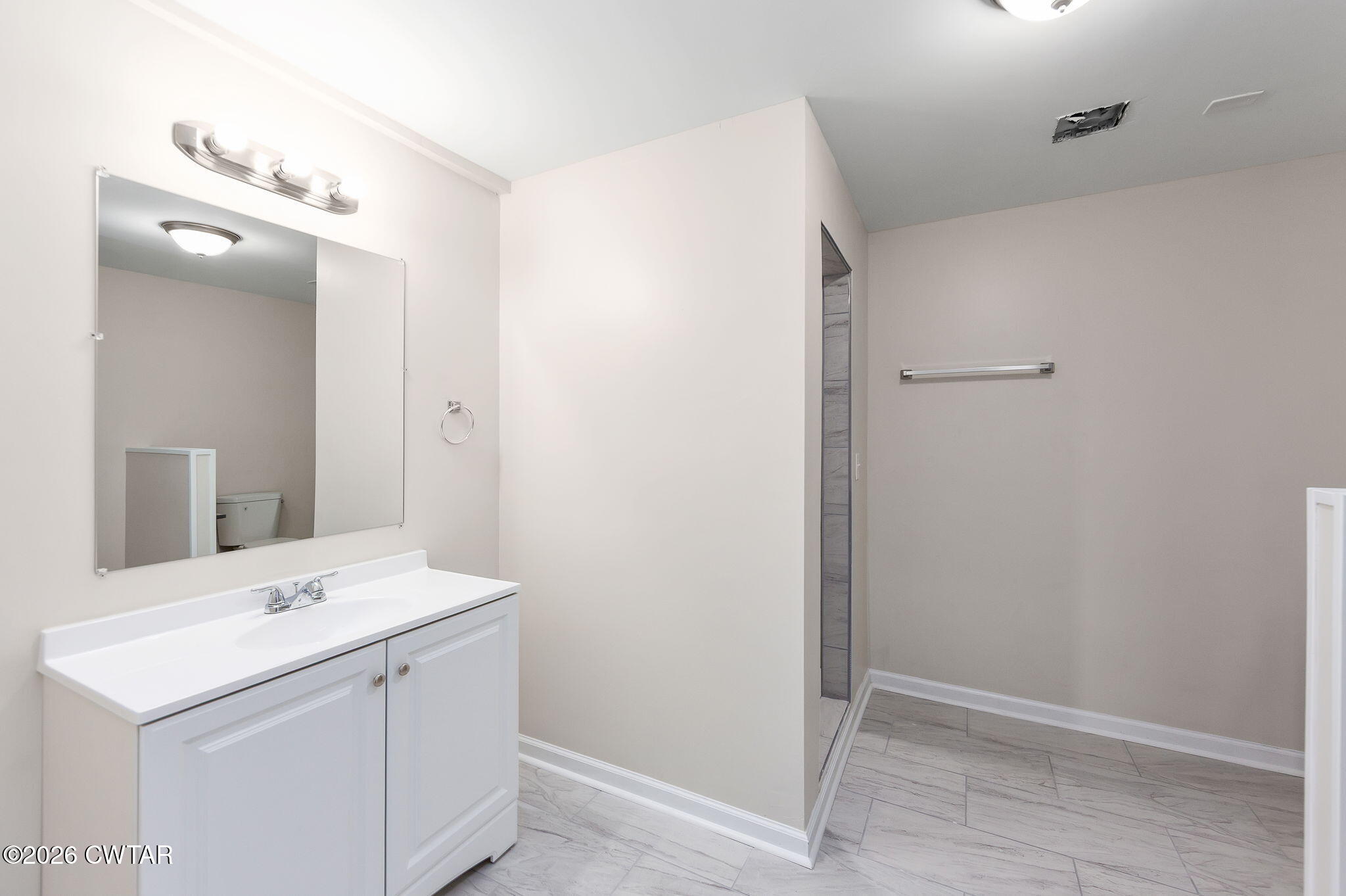 200 Lambuth Boulevard Jackson, TN 38301 - Photo 18 of 28 a bathroom with a sink a large mirror and vanity