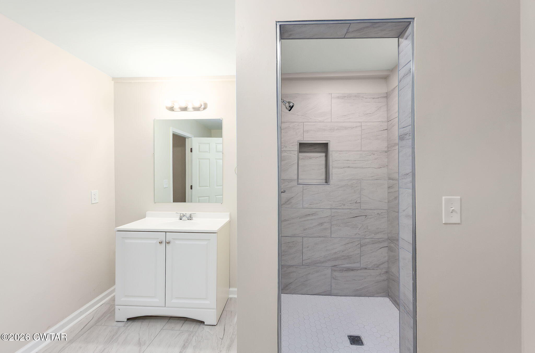 200 Lambuth Boulevard Jackson, TN 38301 - Photo 5 of 28 a bathroom with a mirror a sink and a shower