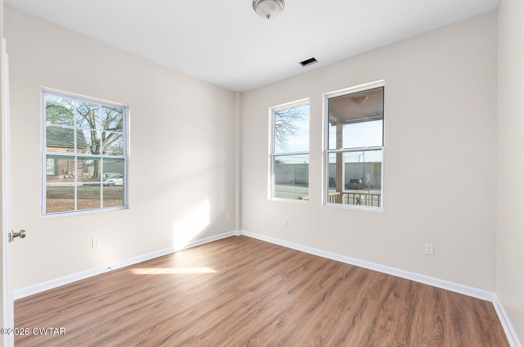 200 Lambuth Boulevard Jackson, TN 38301 - Photo 6 of 28 an empty room with wooden floor and windows
