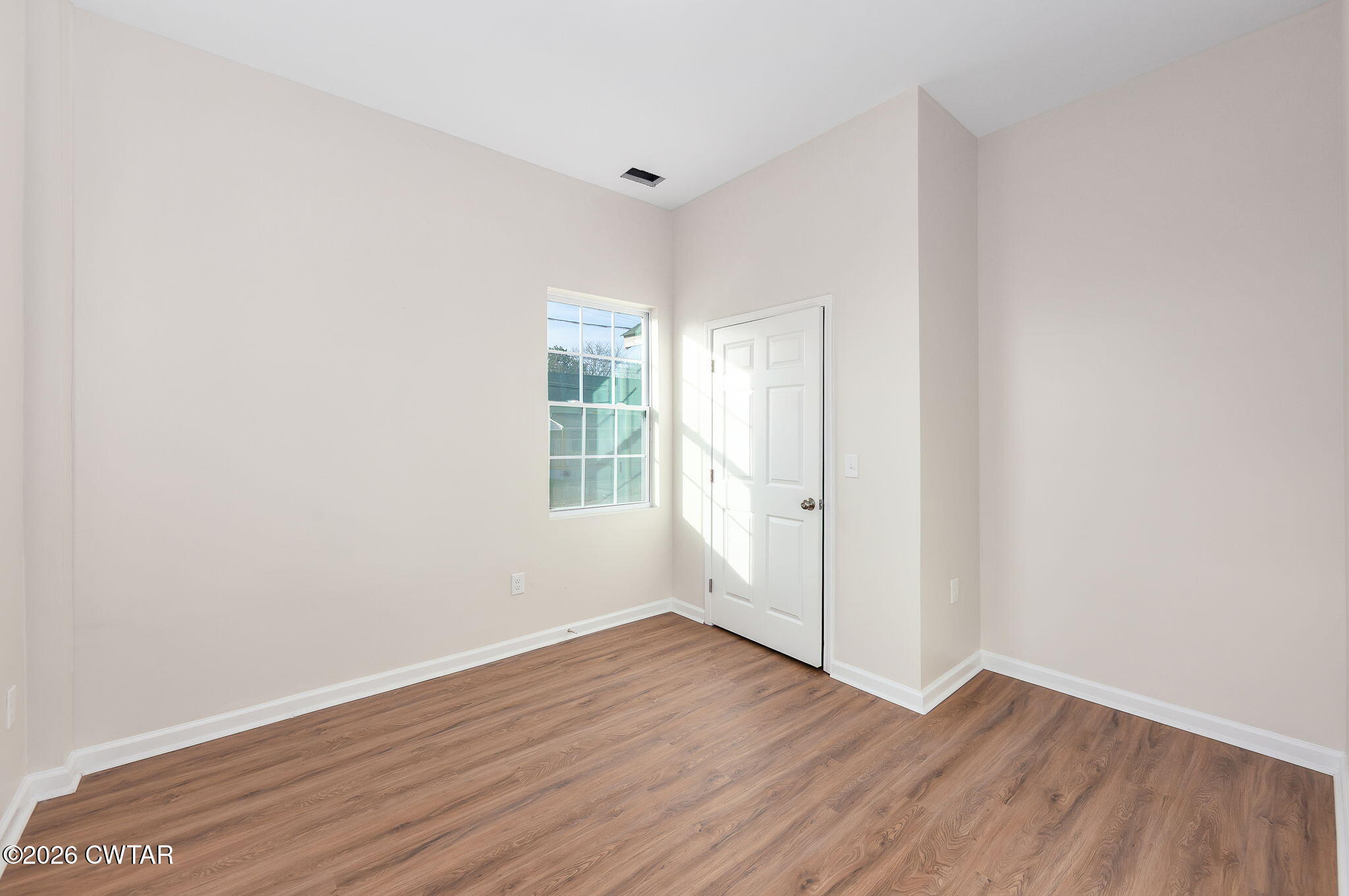 200 Lambuth Boulevard Jackson, TN 38301 - Photo 8 of 28 an empty room with wooden floor and windows