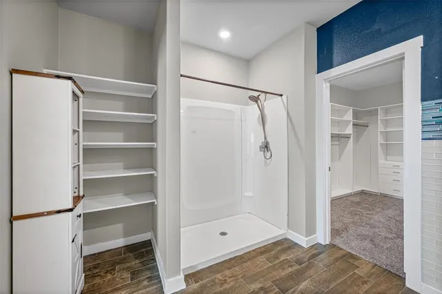 a bathroom with a shower and a glass door