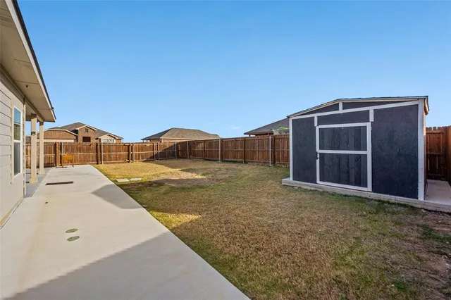a view of house with backyard