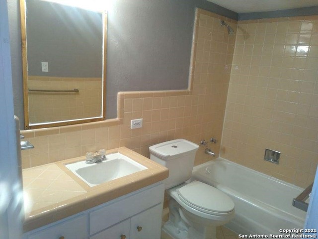 615 Vance Jackson Road, Unit 106 San Antonio, TX 78201 - Photo 9 of 10 a bathroom with a sink a toilet and shower