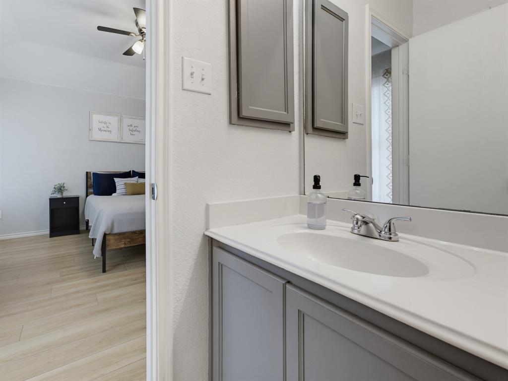 600 Stirling Road Rhome, TX 76078 - Photo 25 of 38 Bathroom vanity featuring a white countertop with an integrated sink and chrome faucet
