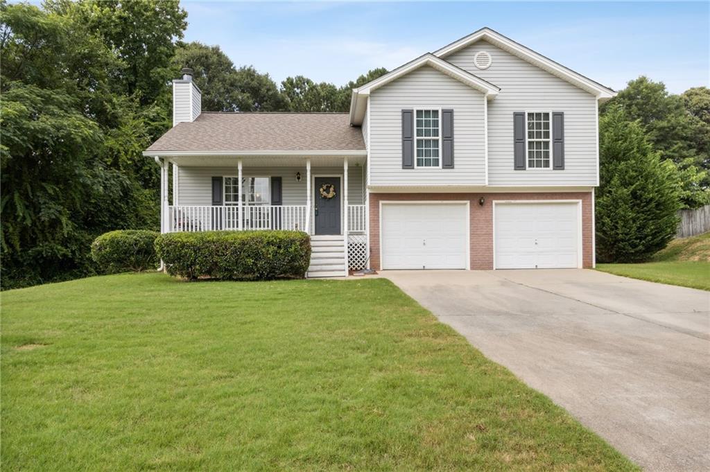 405 Lokey's Ridge Road Bethlehem, GA 30620 - Photo 1 of 1 a front view of a house with a garden
