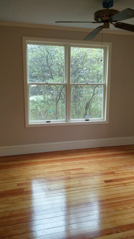 1036 Westhampton Road Northampton, MA 01062 - Photo 6 of 8 a view of an empty room with wooden floor and a window