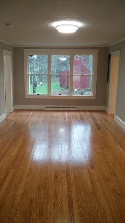 1036 Westhampton Road Northampton, MA 01062 - Photo 7 of 8 an empty room with wooden floor and windows