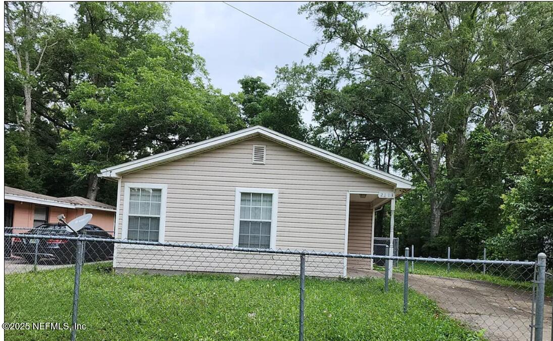 a view of house with backyard