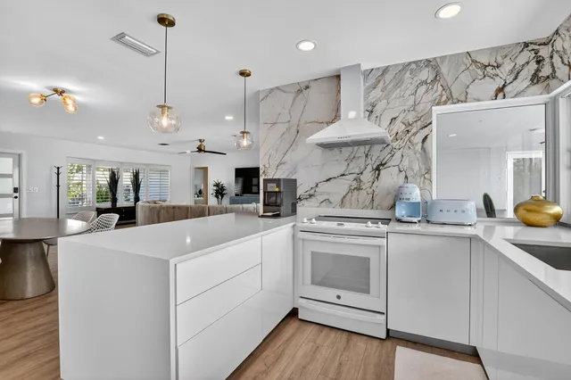 a view of a sink a table and chair in a room