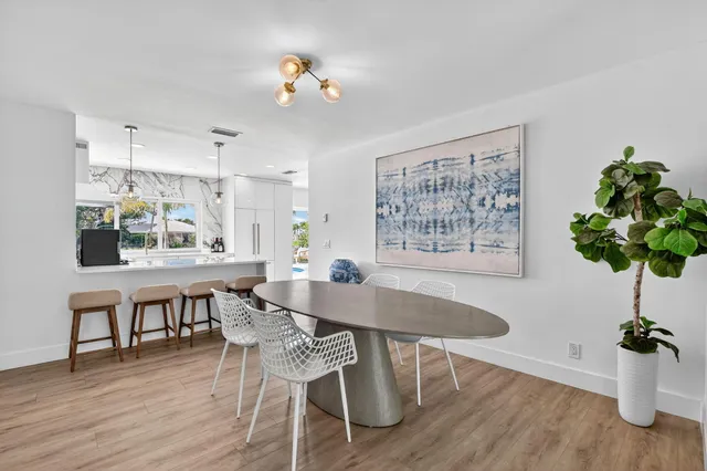 a living room with furniture ceiling fan and a wooden floor