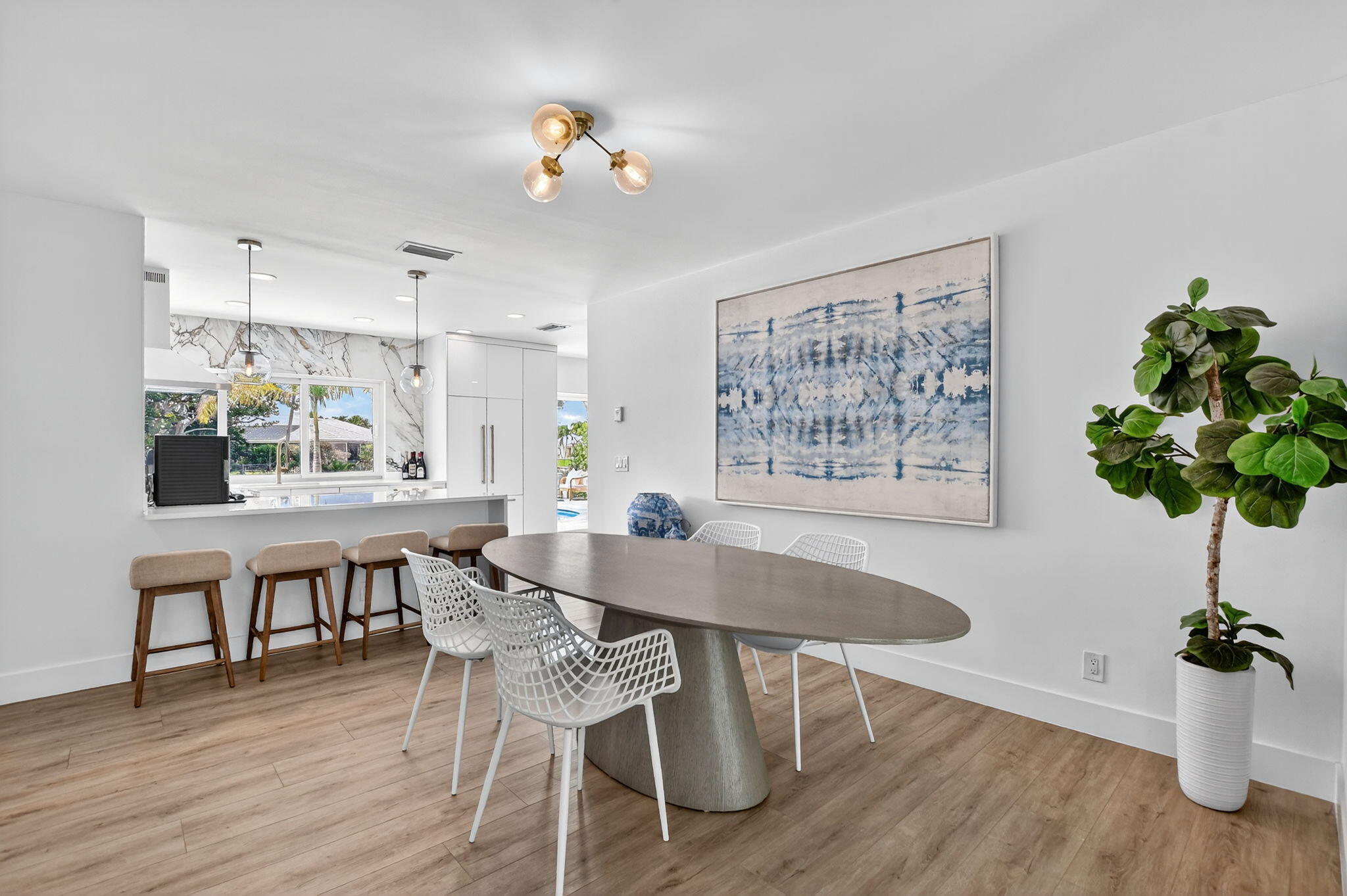 891 Hickory Terrace Boca Raton, FL 33486 - Photo 14 of 56 a dining room with furniture potted plants and wooden floor