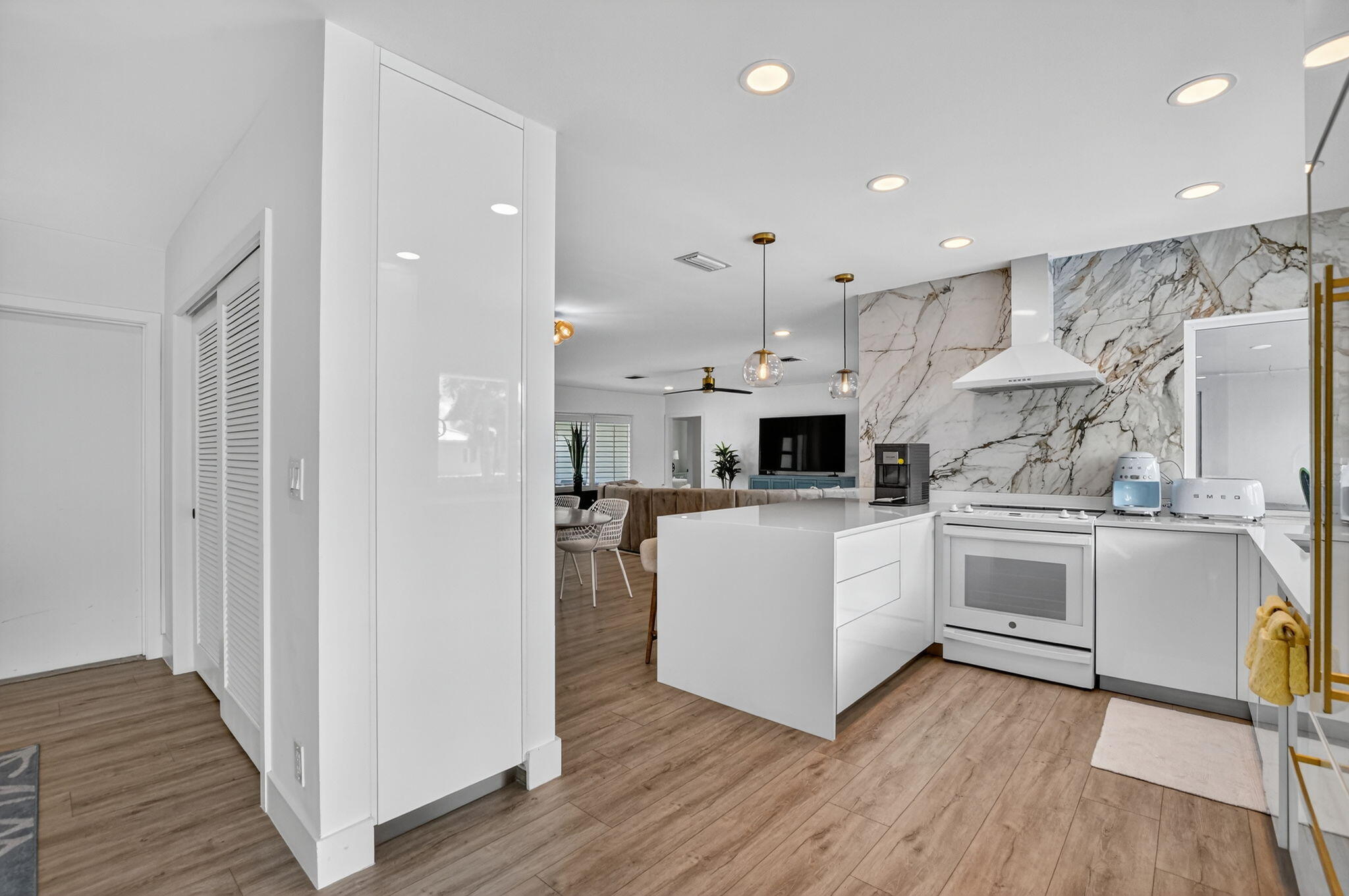 891 Hickory Terrace Boca Raton, FL 33486 - Photo 19 of 56 a kitchen with white cabinets and stainless steel appliances