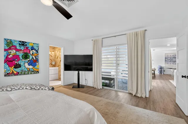 a bathroom with a granite countertop sink a toilet and shower