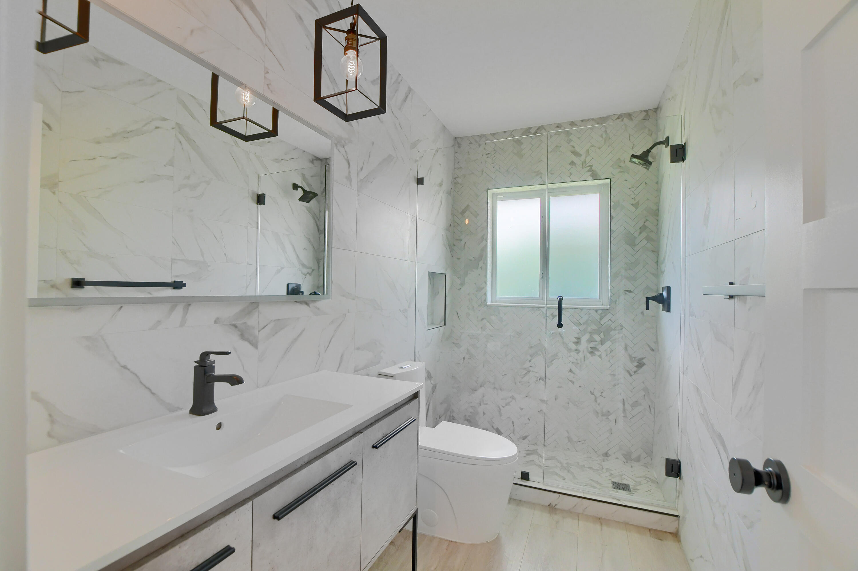 891 Hickory Terrace Boca Raton, FL 33486 - Photo 32 of 56 a bathroom with a sink a toilet and shower