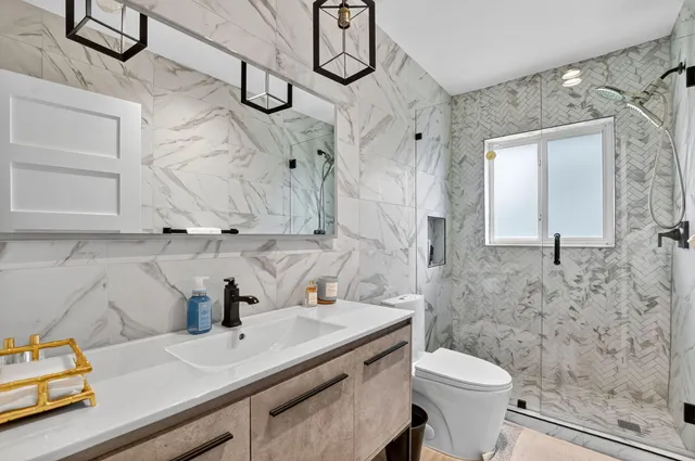 a bedroom with two beds and a chandelier